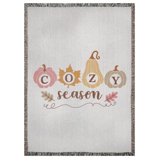 A 37x52 inch woven blanket depicting bohemian-style pumpkins. It says "cozy season".