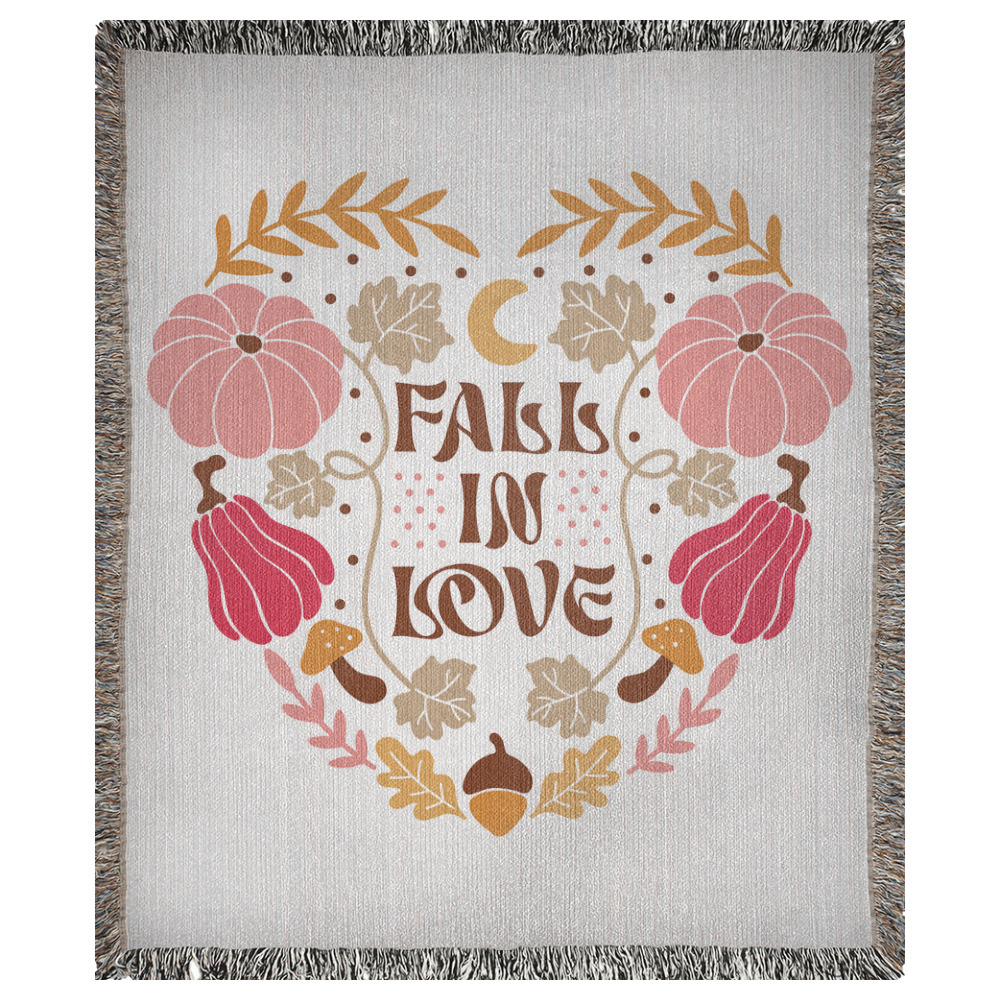 A 50x60 inch woven blanket depicting bohemian-style pumpkins, acorns, leaves, and a moon. It says "fall in love".