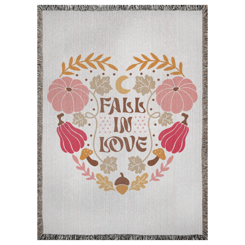 A 37x52 inch woven blanket depicting bohemian-style pumpkins, acorns, leaves, and a moon. It says "fall in love".