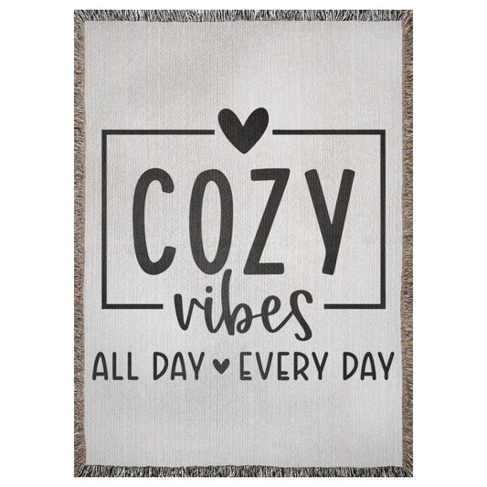 A 37x52 inch woven blanket with the words "cozy vibes all day every day". It has two hearts.