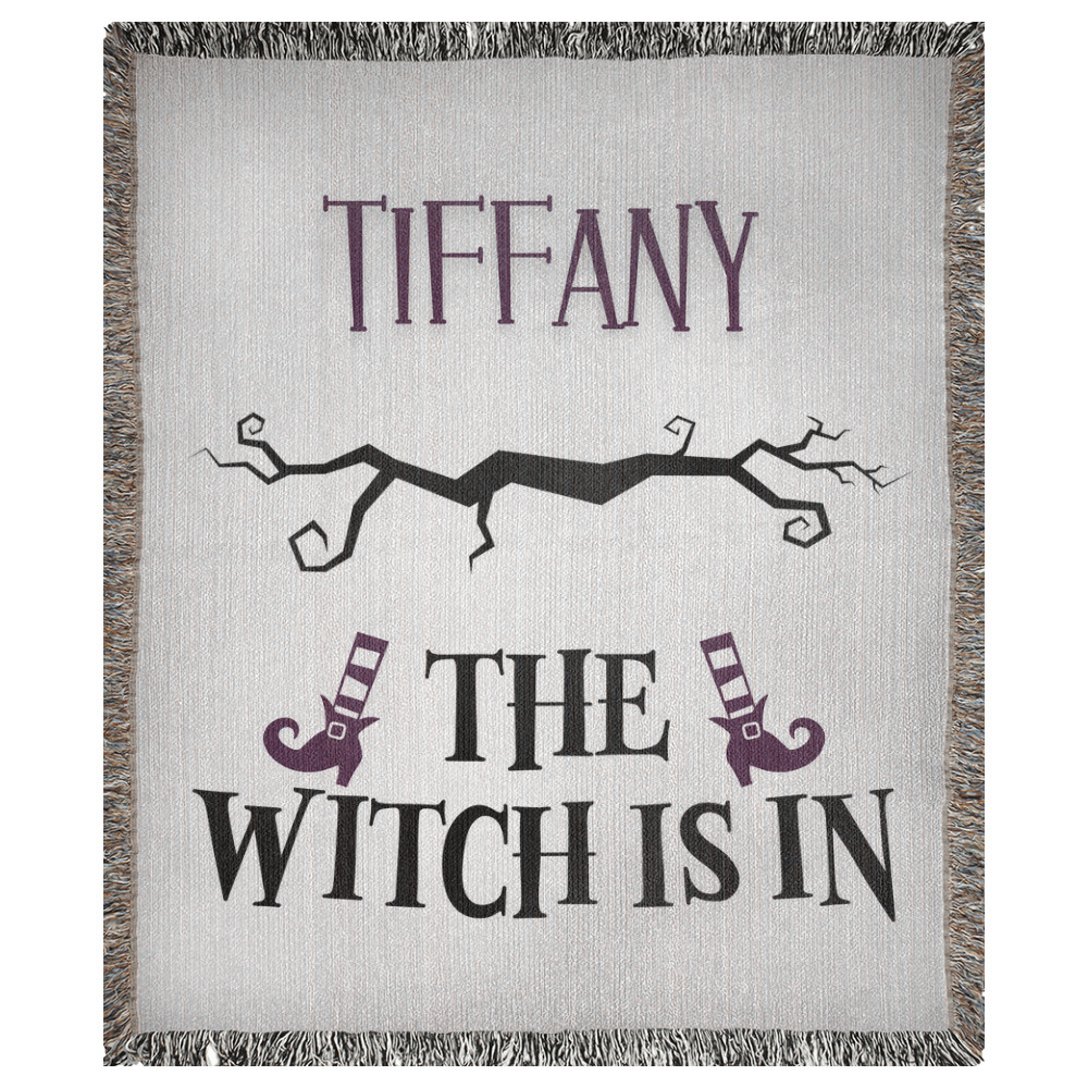 A customizable woven blanket depicting a spooky branch and witch legs with striped socks and boots. This example has the name "Tiffany" and says "the witch is in".